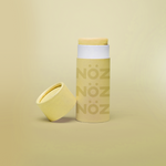 Load image into Gallery viewer, A single yellow Nöz sunscreen stick in front of a yellow background.
