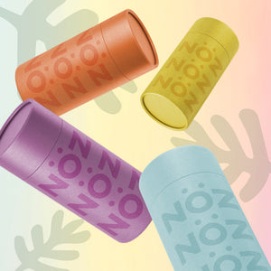 Orange, yellow, purple, blue Nöz sticks and three grey cartoon ferns on a gradient background